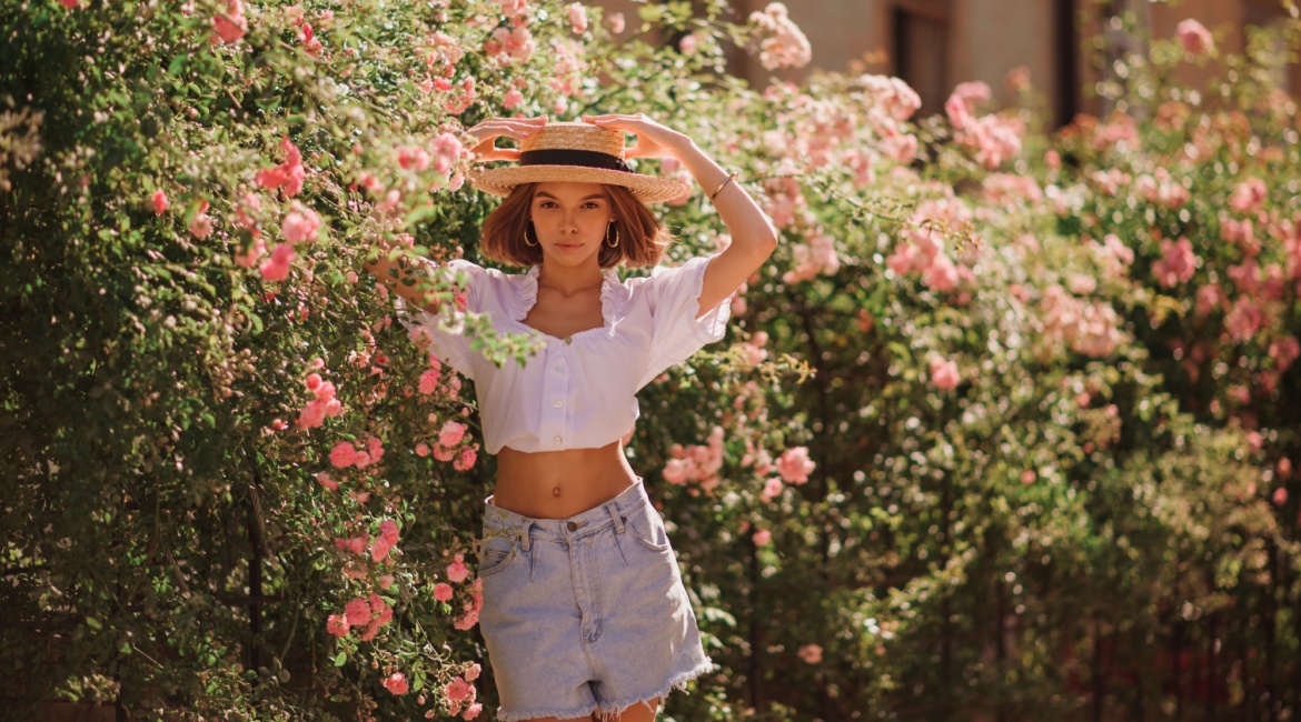 Crop top ženska osoba za radnim stolom jede hamburger